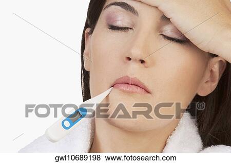 Woman taking her temperature View Large Photo Image Stock Photo - Woman taking her temperature. Fotosearch