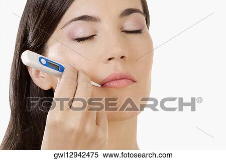Stock Photography - Woman taking her temperature. Fotosearch