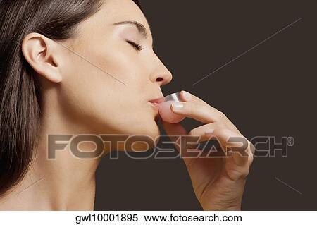Stock Photography - Woman taking medicine. Fotosearch