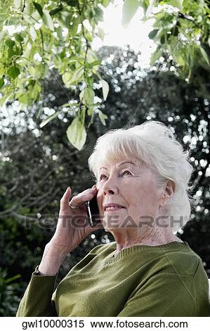Woman talking on mobile phone View Large Photo Image Stock Photography - Woman talking on mobile phone. Fotosearch