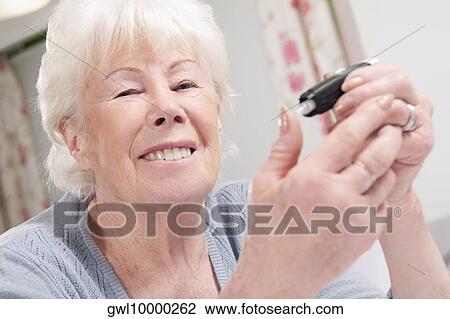 Woman testing her blood sugar level View Large Photo Image Stock Image - Woman testing her blood sugar level. Fotosearch