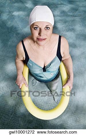 Woman using a pool float in a swimming pool View Large Photo Image Stock Image - Woman using a pool float in a swimming pool. Fotosearch