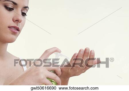 Woman using a soap dispenser View Large Photo Image Stock Image - Woman using a soap dispenser. Fotosearch