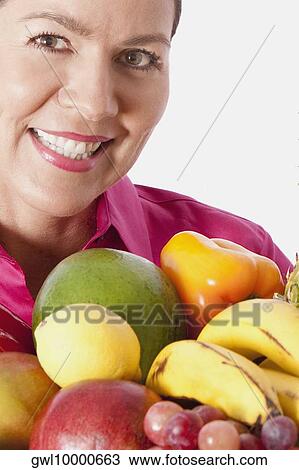 Woman with assorted fruits View Large Photo Image Stock Image - Woman with assorted fruits. Fotosearch