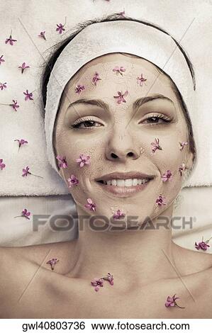Woman with face pack and flowers on her face View Large Photo Image Stock Photograph - Woman with face pack and flowers on her face. Fotosearch
