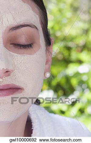 Woman with facial mask on her face View Large Photo Image Stock Image - Woman with facial mask on her face. Fotosearch
