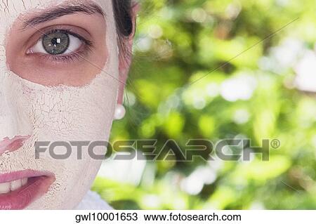 Woman with facial mask on her face View Large Photo Image Stock Image - Woman with facial mask on her face. Fotosearch