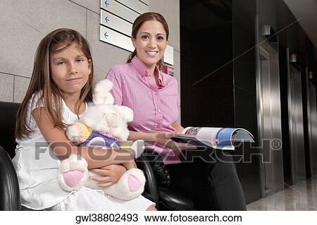 Woman with her daughter in a hospital waiting room View Large Photo Image Stock Image - Woman with her daughter in a hospital waiting room. Fotosearch