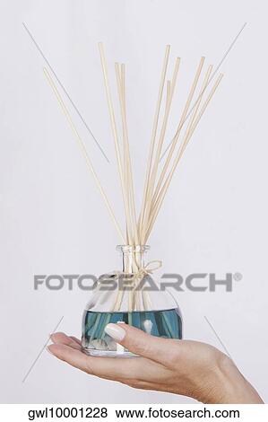 Woman's hand holding an aromatherapy oil bottle with incenses View Large Photo Image Stock Photo - Woman's hand holding an aromatherapy oil bottle with incenses. Fotosearch