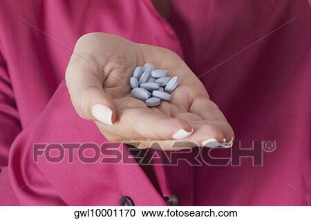 Woman's hand holding pills View Large Photo Image Stock Image - Woman's hand holding pills. Fotosearch