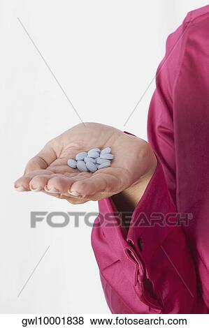 Woman's hand holding pills View Large Photo Image Stock Photo - Woman's hand holding pills. Fotosearch