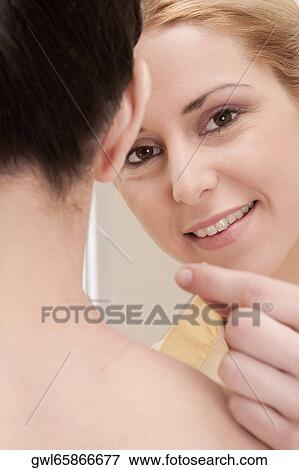 Stock Photo - Acupuncturist applying needles on a woman's back. Fotosearch