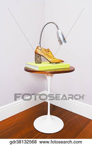 Stock Photo - Angle-poise lamp on a table. Fotosearch