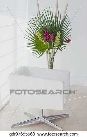Armchair with a houseplant in a room View Large Photo Image Stock Image - Armchair with a houseplant in a room. Fotosearch