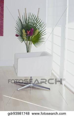Armchair with a houseplant in a room View Large Photo Image Stock Photo - Armchair with a houseplant in a room. Fotosearch