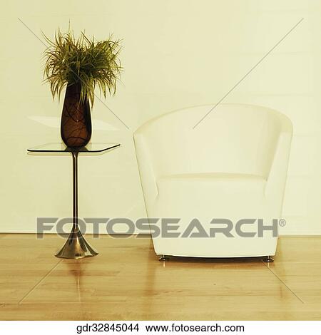 Armchair with a showpiece in a room View Large Photo Image Picture - Armchair with a showpiece in a room. Fotosearch