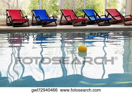Stock Photograph - Ball floating in a swimming pool. Fotosearch