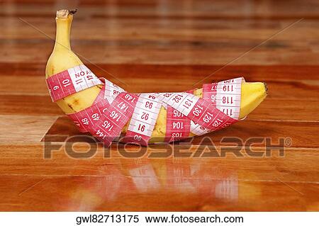 Banana wrapped in a tape measure View Large Photo Image Stock Photography - Banana wrapped in a tape measure. Fotosearch
