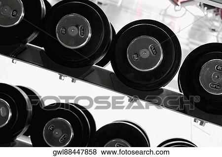 Barbells in a gym View Large Photo Image Stock Photo - Barbells in a gym. Fotosearch