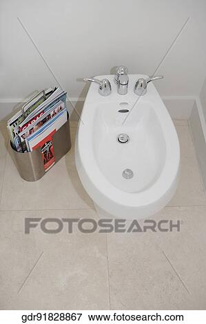 Bathroom sink with magazines in the bathroom View Large Photo Image Stock Photo - Bathroom sink with magazines in the bathroom. Fotosearch