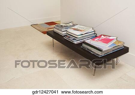 Stock Image - Books on a table in the living room. Fotosearch