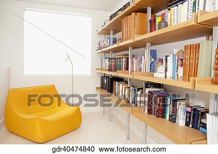 Bookshelf and a chair in the living room View Large Photo Image Stock Image - Bookshelf and a chair in the living room. Fotosearch