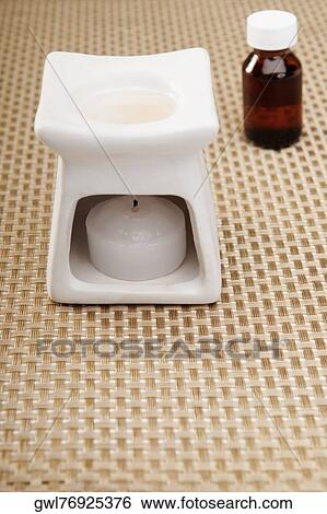Bottle of aromatherapy oil and a burner View Large Photo Image Stock Photograph - Bottle of aromatherapy oil and a burner. Fotosearch
