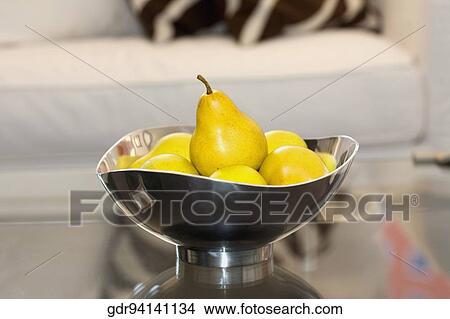 Picture - Bowl of artificial pears on a table. Fotosearch