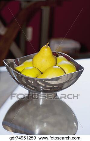 Bowl of artificial pears on a table View Large Photo Image Stock Photo - Bowl of artificial pears on a table. Fotosearch