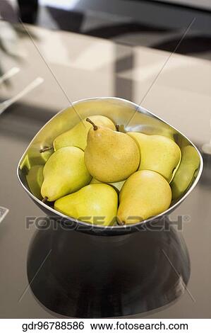 Stock Photograph - Bowl of artificial pears on a table. Fotosearch
