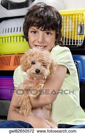Boy carrying a puppy in a supermarket View Large Photo Image Stock Image - Boy carrying a puppy in a supermarket. Fotosearch