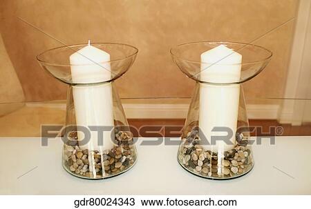 Candles in candlestick holders on a table View Large Photo Image Stock Image - Candles in candlestick holders on a table. Fotosearch
