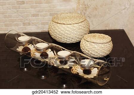 Stock Image - Candlestick holder with wicker baskets in the bathroom. Fotosearch