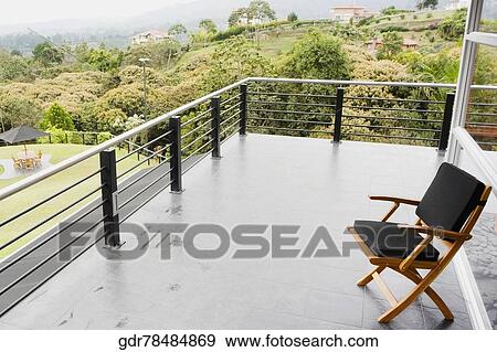Chair on a balcony View Large Photo Image Stock Photo - Chair on a balcony. Fotosearch