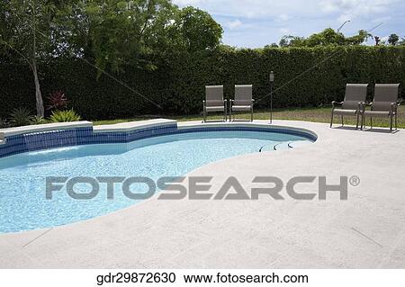 Chairs at the poolside View Large Photo Image Stock Image - Chairs at the poolside. Fotosearch
