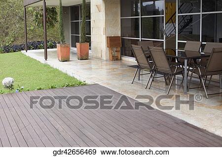 Chairs in the porch in front of a house View Large Photo Image Stock Photo - Chairs in the porch in front of a house. Fotosearch