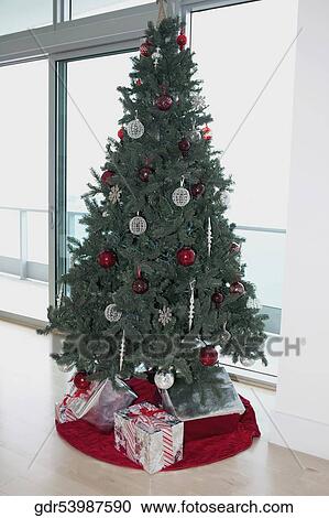 Christmas tree with gifts in a room View Large Photo Image Stock Image - Christmas tree with gifts in a room. Fotosearch