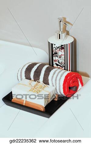 Close-up of a bar of soap with towel and soap dispenser View Large Photo Image Stock Image - Close-up of a bar of soap with towel and soap dispenser. Fotosearch
