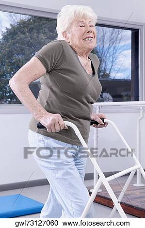 Close-up of a disabled woman walking with a walker View Large Photo Image Stock Image - Close-up of a disabled woman walking with a walker. Fotosearch