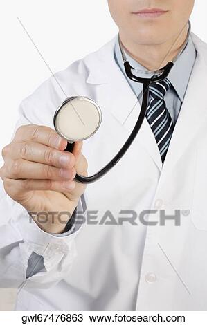Close-up of a doctor holding a stethoscope View Large Photo Image Stock Image - Close-up of a doctor holding a stethoscope. Fotosearch