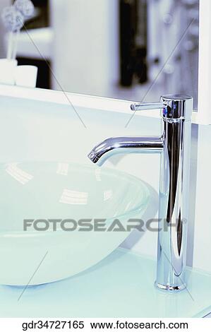 Close-up of a faucet on a bathroom sink View Large Photo Image Stock Photography - Close-up of a faucet on a bathroom sink. Fotosearch