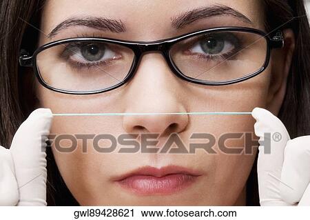 Close-up of a female dentist holding dental floss View Large Photo Image Stock Image - Close-up of a female dentist holding dental floss. Fotosearch