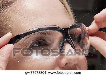 Close-up of a female doctor wearing a protective eyewear View Large Photo Image Picture - Close-up of a female doctor wearing a protective eyewear. Fotosearch
