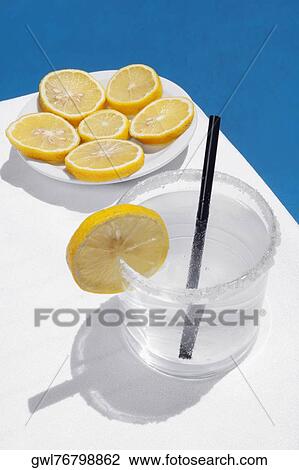 Close-up of a glass of lemonade with lemon slices View Large Photo Image Stock Image - Close-up of a glass of lemonade with lemon slices. Fotosearch