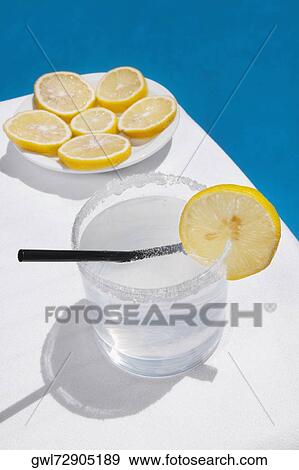 Stock Photo - Close-up of a glass of lemonade with lemon slices. Fotosearch