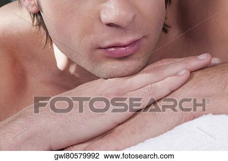 Stock Image - Close-up of a man lying on a massage table. Fotosearch