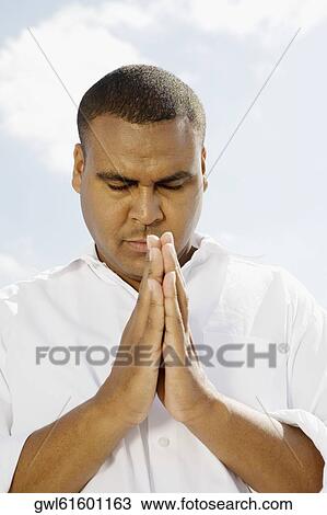 Close-up of a man meditating View Large Photo Image Stock Image - Close-up of a man meditating. Fotosearch