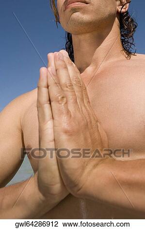 Stock Image - Close-up of a man meditating. Fotosearch