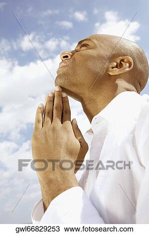 Close-up of a man meditating View Large Photo Image Stock Image - Close-up of a man meditating. Fotosearch