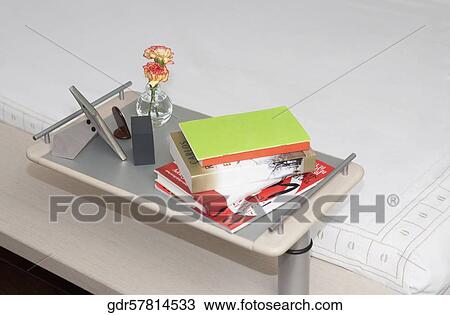 Close-up of a night table along with a bed View Large Photo Image Stock Image - Close-up of a night table along with a bed. Fotosearch
